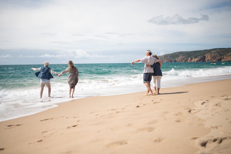 People Walking At The Beach 