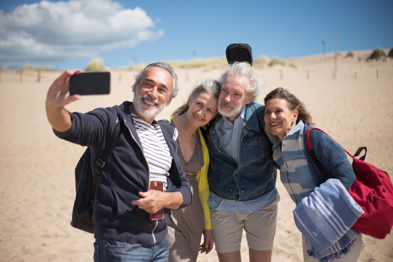 Group of senior friends enjoying a beach holiday in Portugal