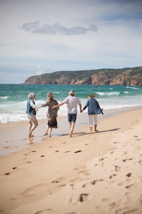 People Walking On Seashore