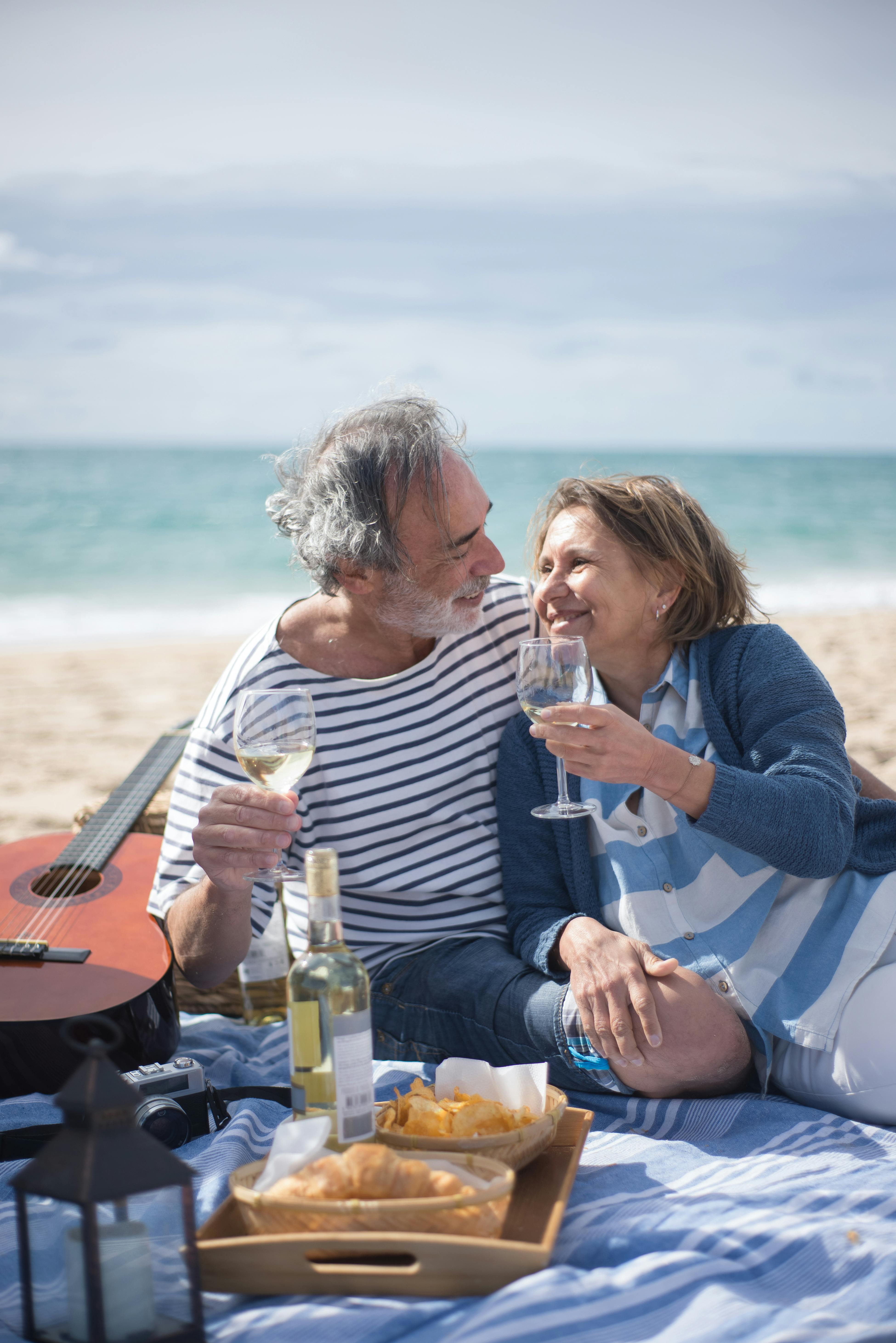 Elderly Couple having a Picnic at the Beach · Free Stock Photo