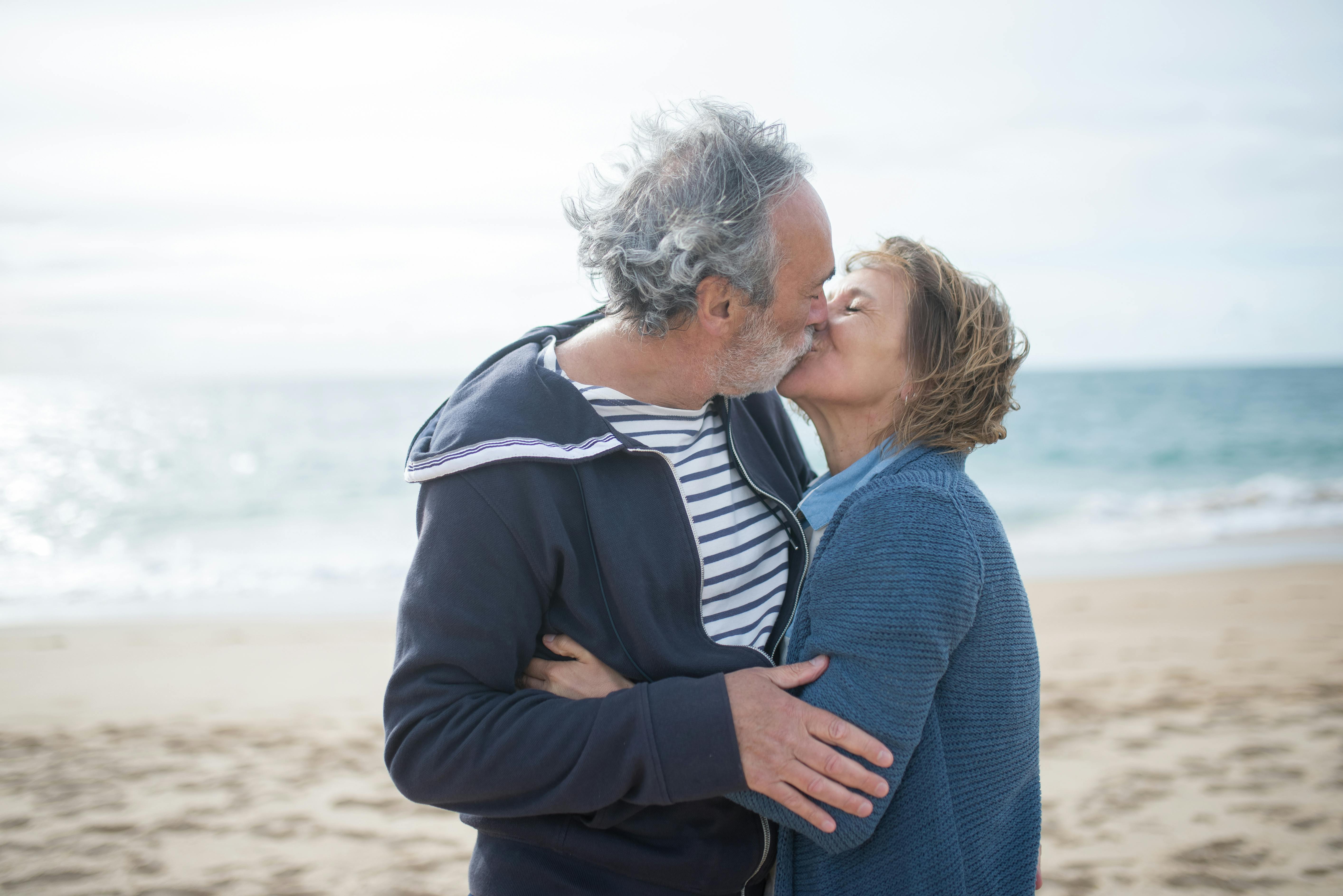 An Elderly Couple Kissing at the Beach · Free Stock Photo