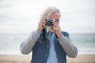 Woman in Blue Denim Jacket Holding Camera