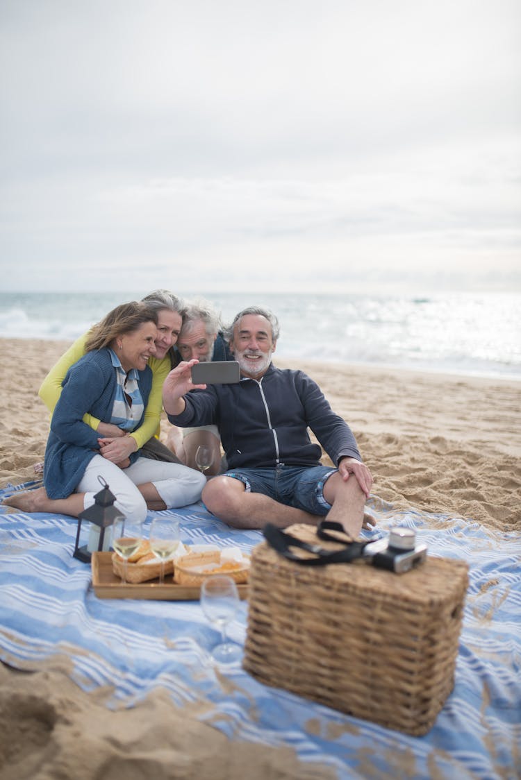 Mature People Taking Photo At The Beach 