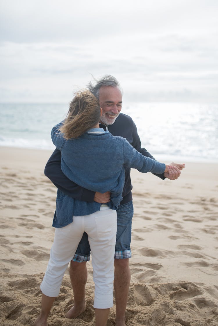 Elderly Couple Dancing On The Beach