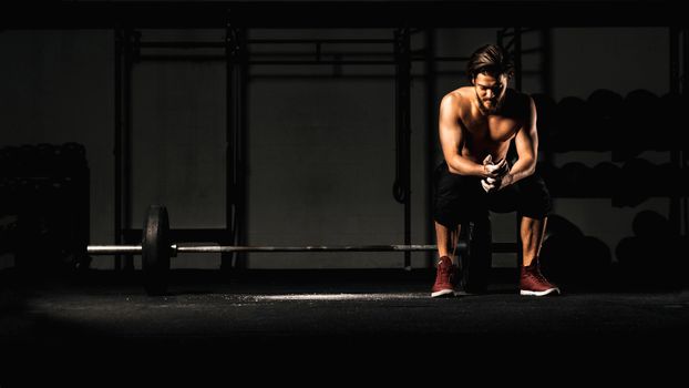 Man Inside a Gym near a Barbell