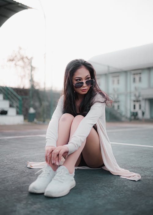 Woman in White Cardigan and Black Sunglasses