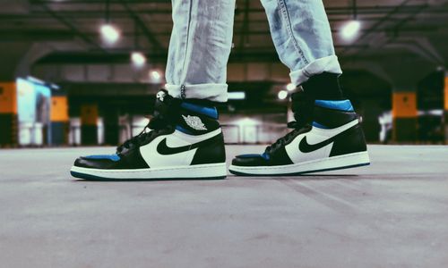 Free Close-up of sneakers in modern streetwear style, indoors parking lot. Stock Photo