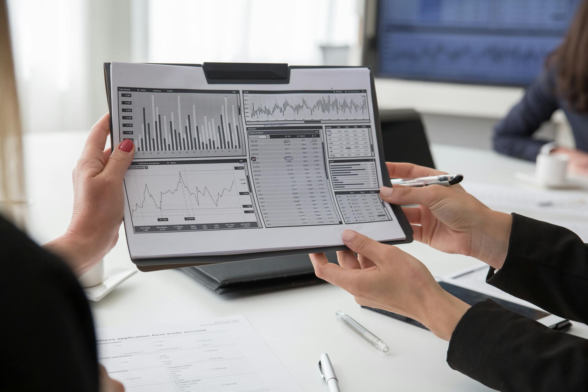 Close-up of Holding Papers with Graphs