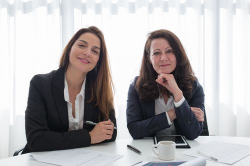 Free Smiling professionals in business attire at an office meeting in Portugal. Stock Photo