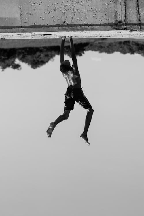 Monochrome Photo of a Man Performing a Handstand
