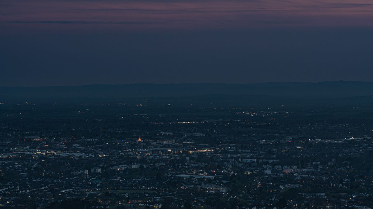 Cheltenham and the Severn Vale seen at dusk from the Cotswold escarpment