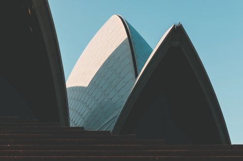 Free Close-up view of the Sydney Opera House showcasing modern architecture under a clear sky. Stock Photo
