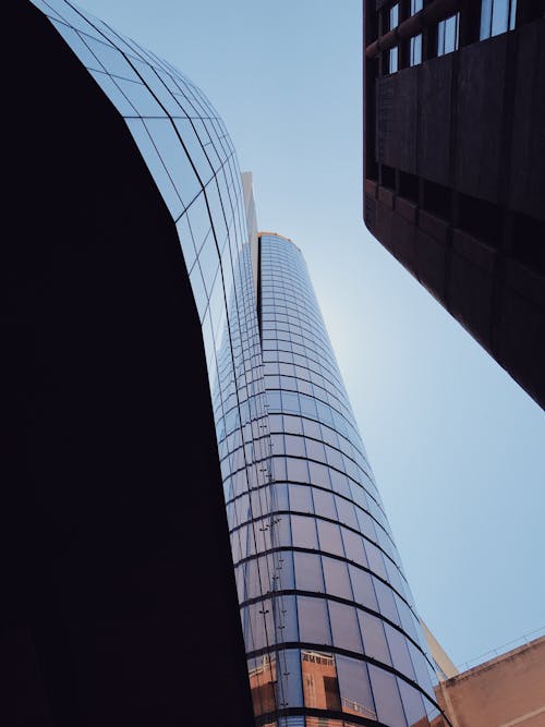 Free Low-Angle Shot of a Tall Building with Glass Windows Stock Photo