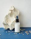 White and Black Bottle Beside White Rock