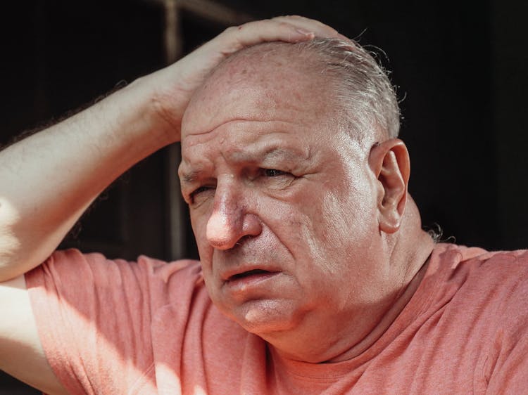 Close Up Photo Of Man With His Hand On His Head