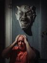 A Man Holding His Head