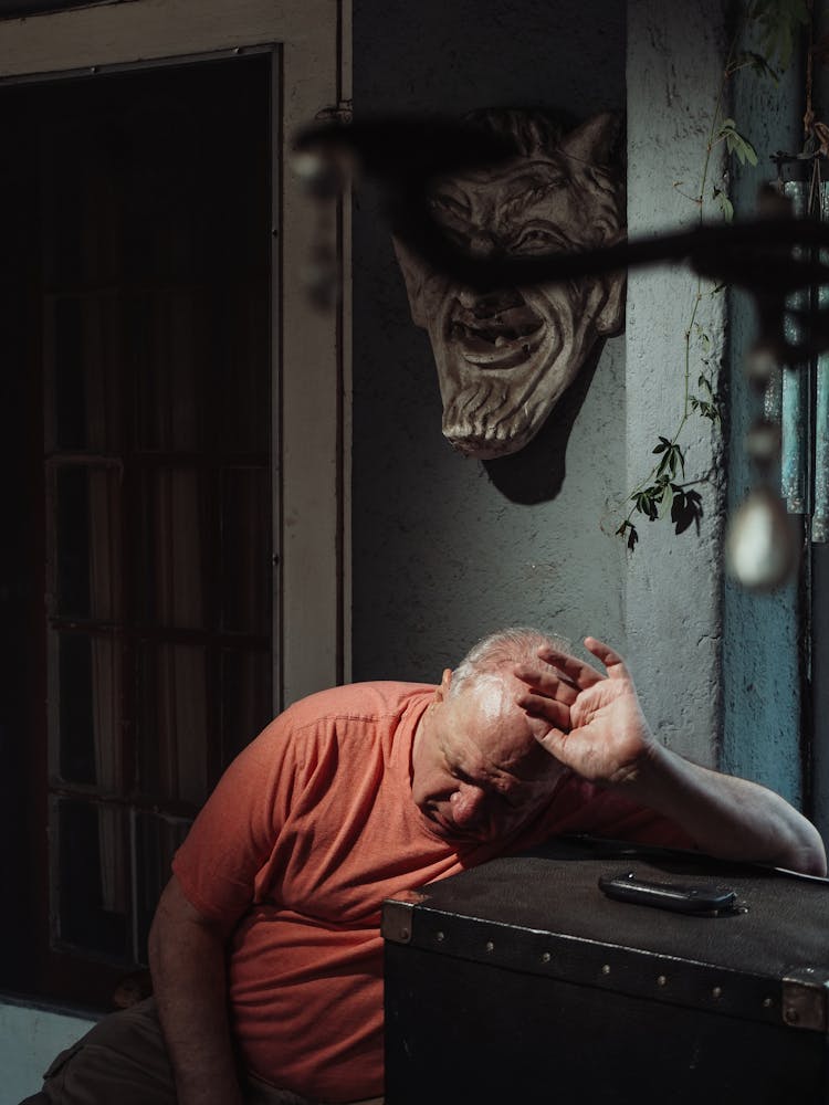 A Depressed Man Leaning On A Box