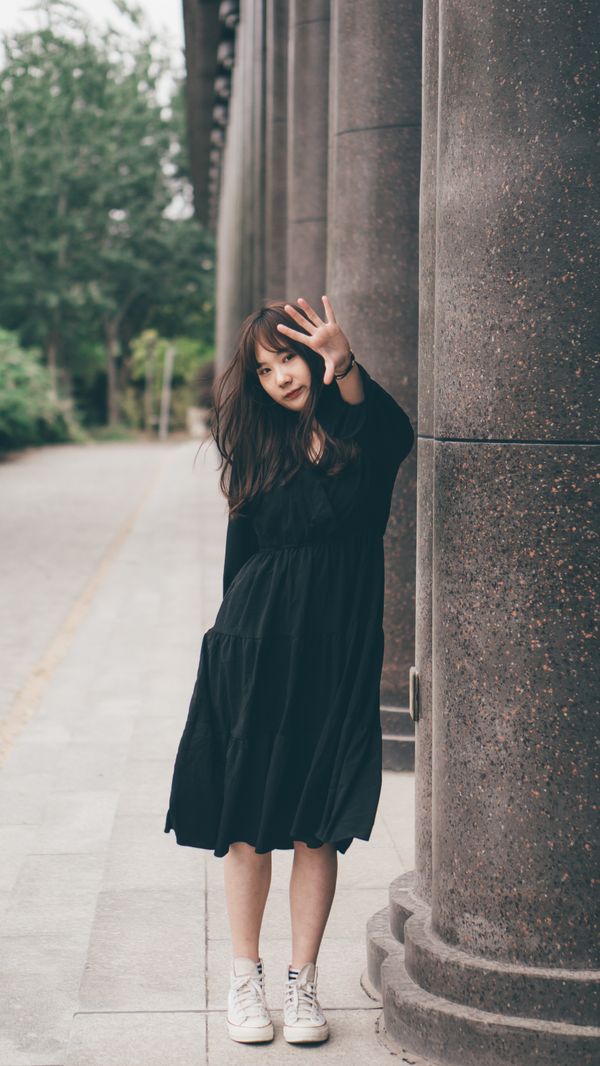 Woman in a casual midi dress with white sneakers