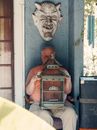 An Elderly Man with a Birdcage on His Laps