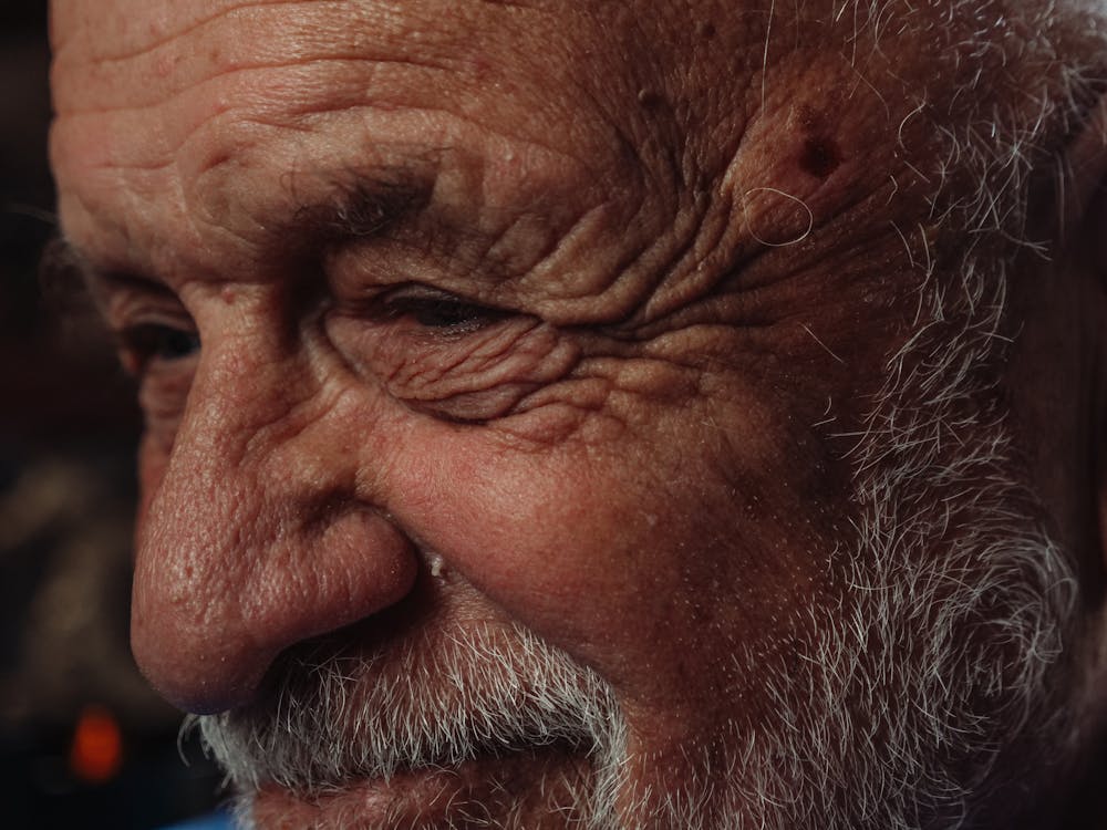 Free 
A Close-Up Shot of a Bearded Elderly Man's Face Stock Photo