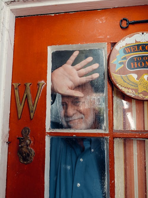 Elderly Man Holding a Glass Window