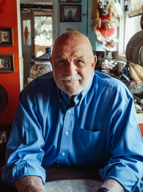 Free Elderly man with a beard smiling warmly in a cozy room. Stock Photo