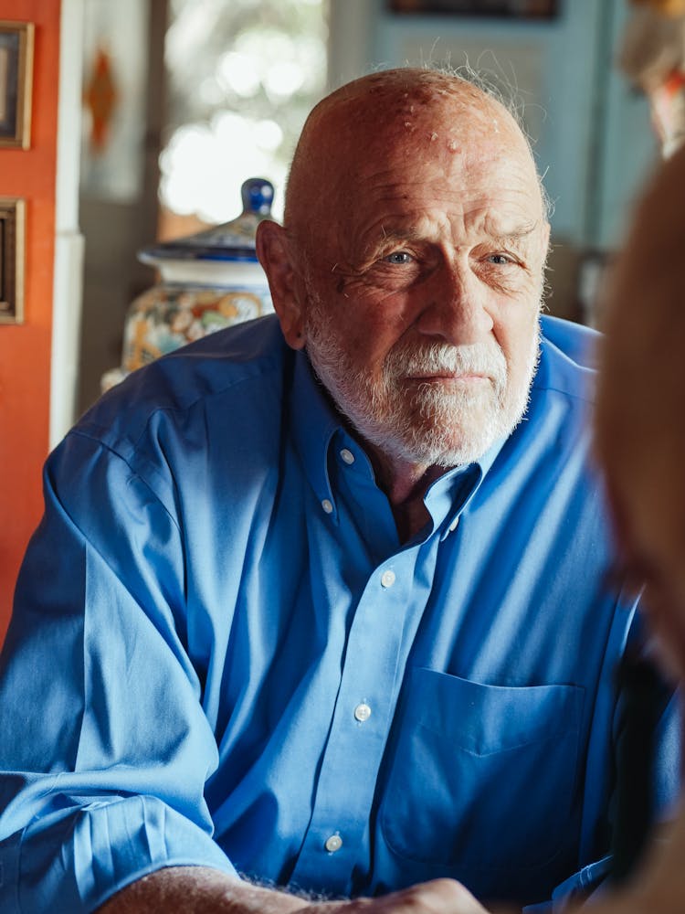 An Elderly Man In A Button Down Shirt 