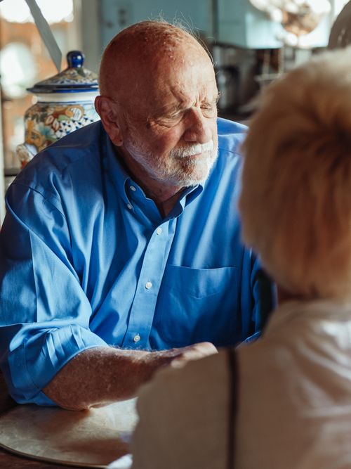 Free Elderly man in blue shirt in a reflective moment indoors, hinting at nostalgia. Stock Photo