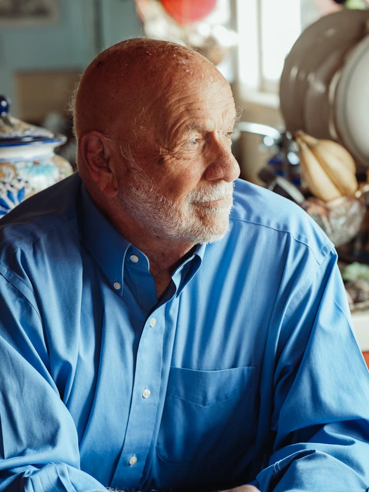 An Elderly Man In A Button Down Shirt