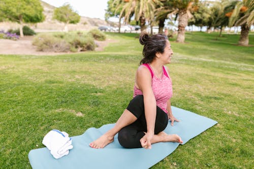 An Elderly Woman Sitting on a Yoga Mat