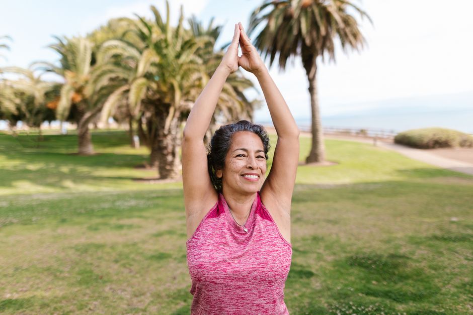 woman practicing general flexibility work in a park - best exercises to prevent osteoporosis woman practicing general flexibility work in a park - best exercises to prevent osteoporosis
