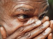 Man Covering His Face With His Hand