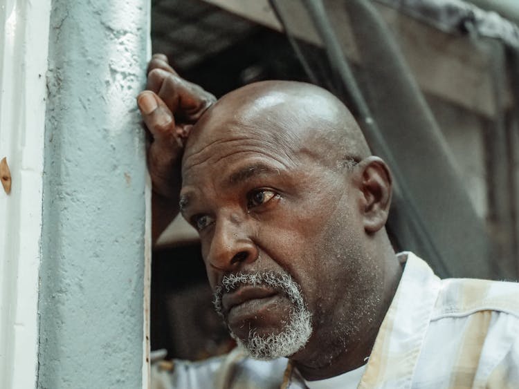 A Low Angle Shot Of An Elderly Man Crying