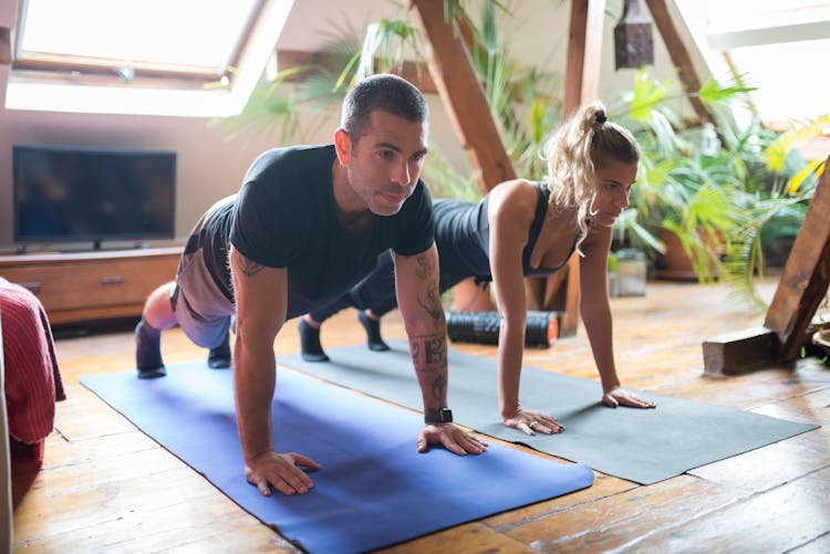 Man And Woman Doing Push Ups Together