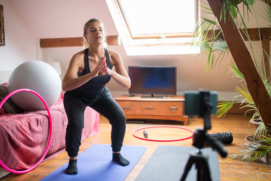 Free A Woman Doing Exercise while Recording Herself Stock Photo