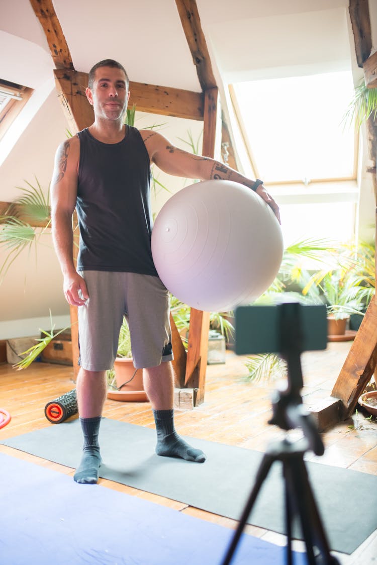 A Man Holding A Yoga Ball