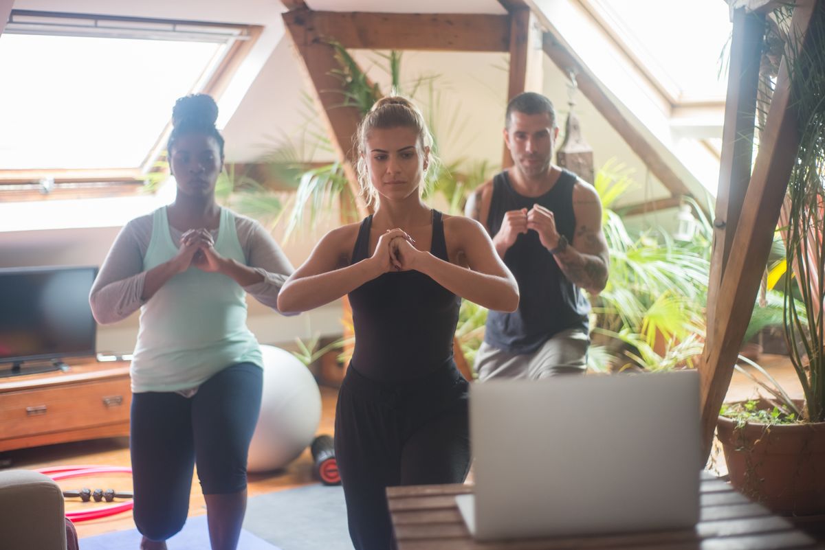 Women and man exercising together at home during an AMRAP circuit workout