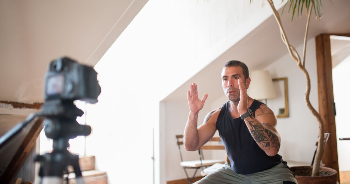 Crafting an Online Presence: A fitness coach recording a workout video for social media