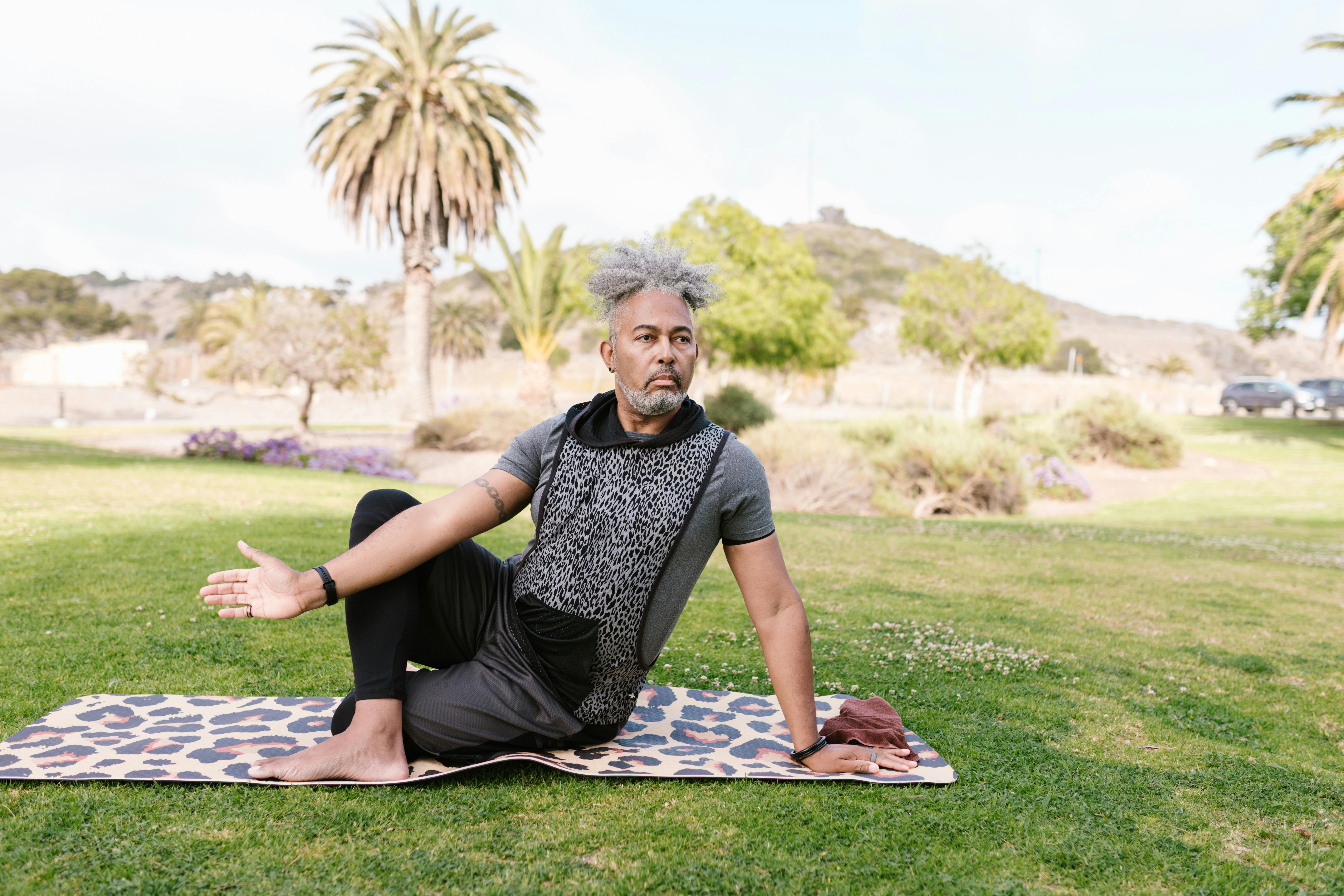 Man Sitting on Yoga Mat While Meditating · Free Stock Photo