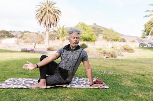 Man Sitting on Yoga Mat While Meditating