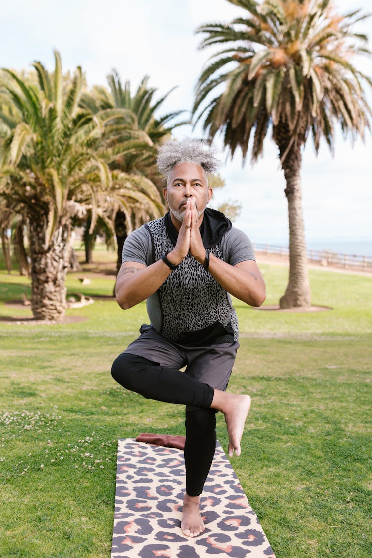 Man Training Yoga In Park