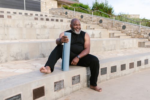 A Man Holding Yoga Mat