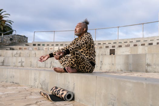 Man practicing yoga outdoors in an urban amphitheater wearing leopard print attire.