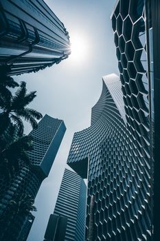 Explore Singapore's futuristic skyscrapers and urban architecture under the bright sun.