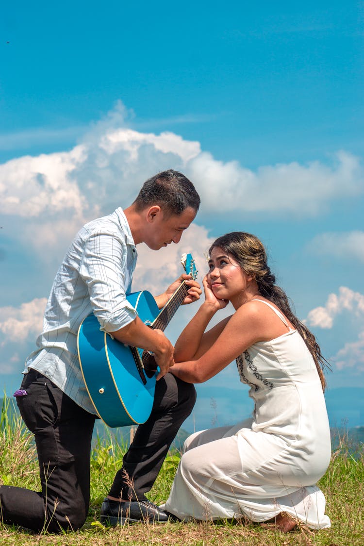 Man Serenading His Girlf On Guitar