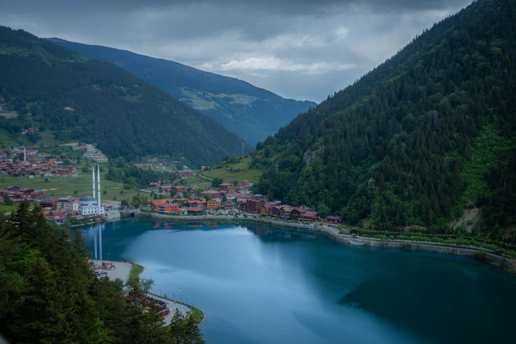 City On Lake Shore In Valley