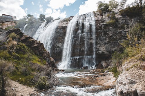 Low Angle Shot of a Waterfall on the Rocks