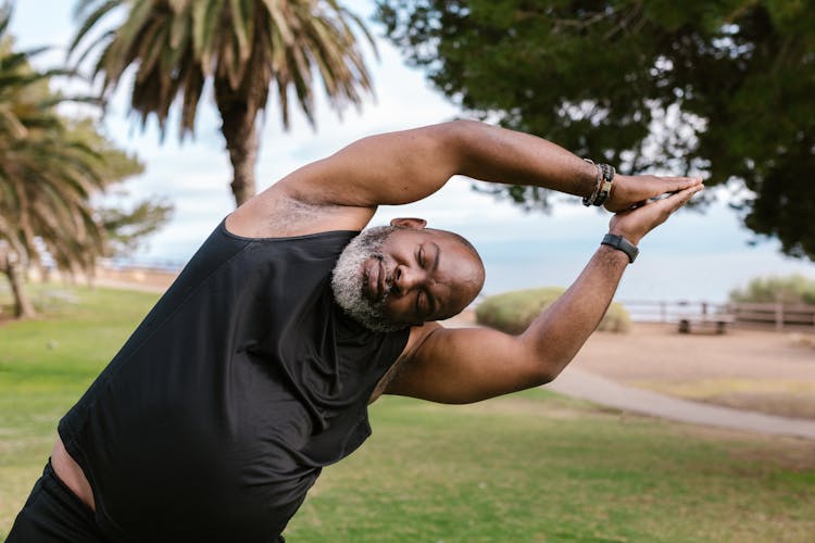 Man In Black Tank Top Doing Yoga