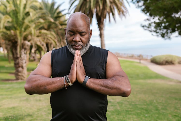 Man Training Yoga In Park