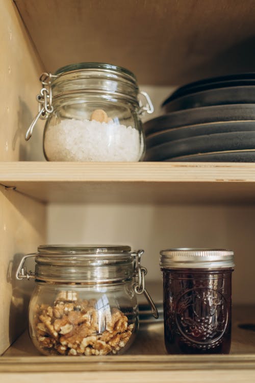 A Close-Up Shot of Glass Jars on Shelves